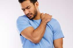 Back pain, asian man and hand in studio for spine, strain and muscle injury on white background. Inflammation, healthcare and neck from accident, male person and sprain trauma for body scoliosis.